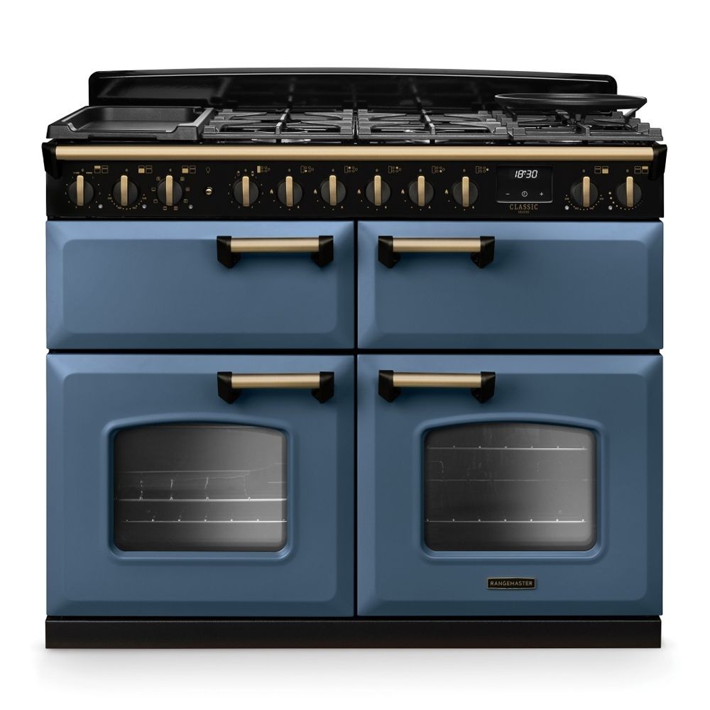 Classic Deluxe 110cm dual fuel range cooker in stone blue with antique brass accents, featuring four gas burners, two ovens with glass doors, and a sleek black control panel.