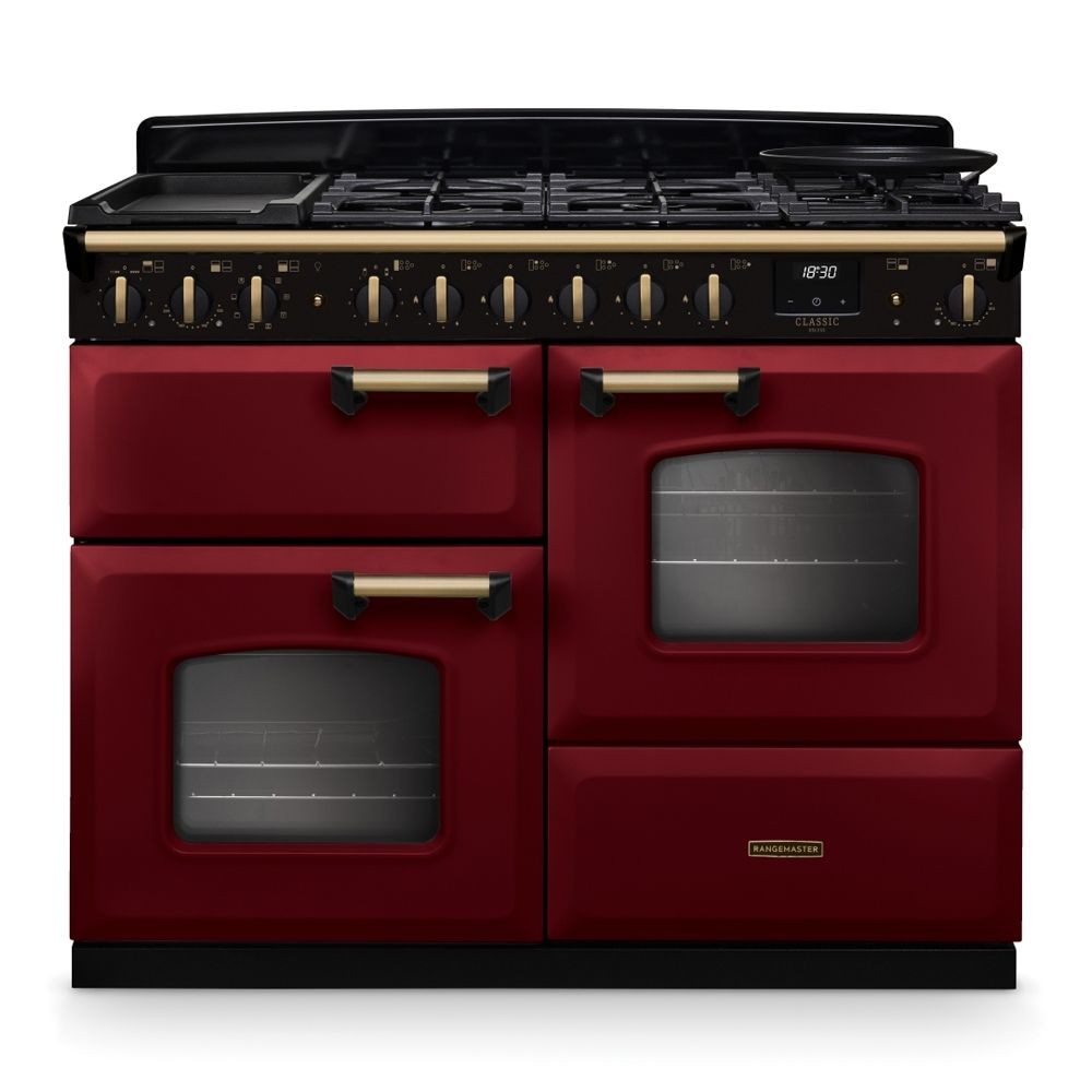 Classic Deluxe 110cm dual fuel range cooker in Bordeaux red and antique brass, featuring a black gas hob with multiple burners and two large glass-fronted ovens.
