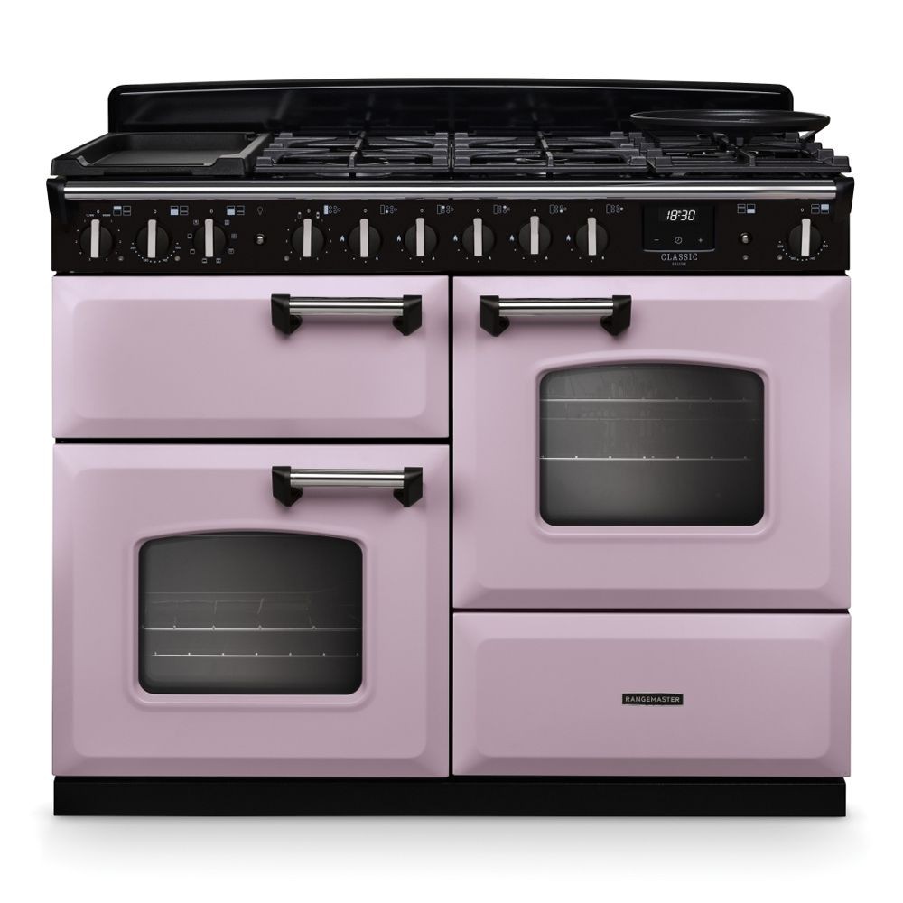 Classic Deluxe 110cm dual fuel range cooker in heather pink and chrome, featuring two ovens, a five-burner gas hob, and sleek control knobs.