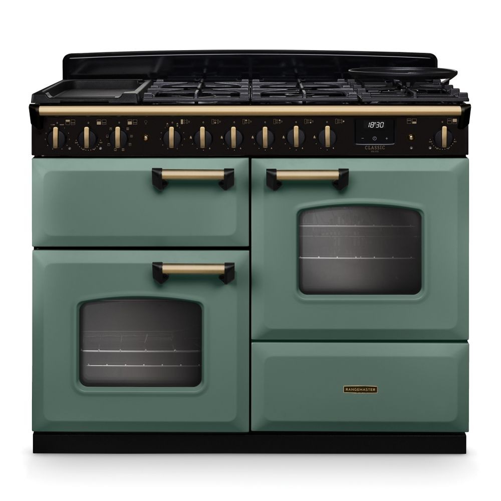 Classic Deluxe 110cm dual fuel range cooker in mineral green with antique brass accents, featuring four gas burners, two ovens, and a griddle on top.