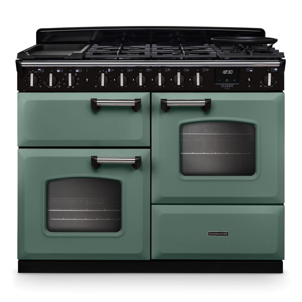 Classic Deluxe 110cm dual fuel range cooker in mineral green with chrome accents, featuring four gas burners, two ovens, and a griddle on top.