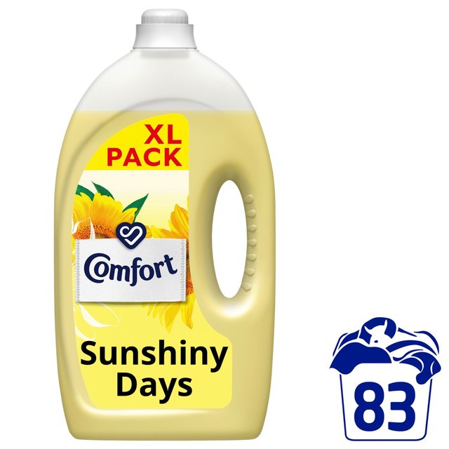 Yellow plastic bottle of Comfort Fabric Conditioner labeled "Sunshiny Days," featuring a sunflower design, with 2490ml capacity and 83 washes indicated on the side.