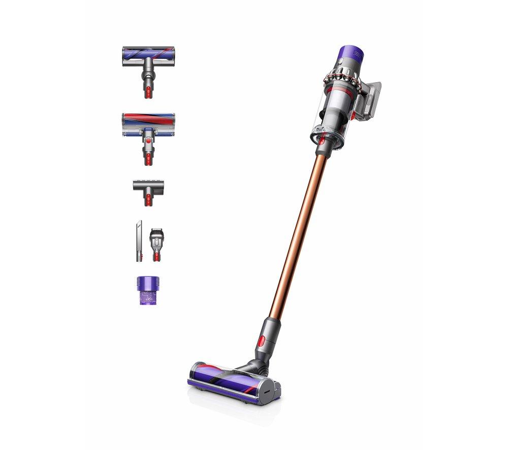 Dyson V10 Absolute cordless stick vacuum cleaner in copper and purple, featuring multiple attachments, a sleek design, and a high-efficiency filtration system.