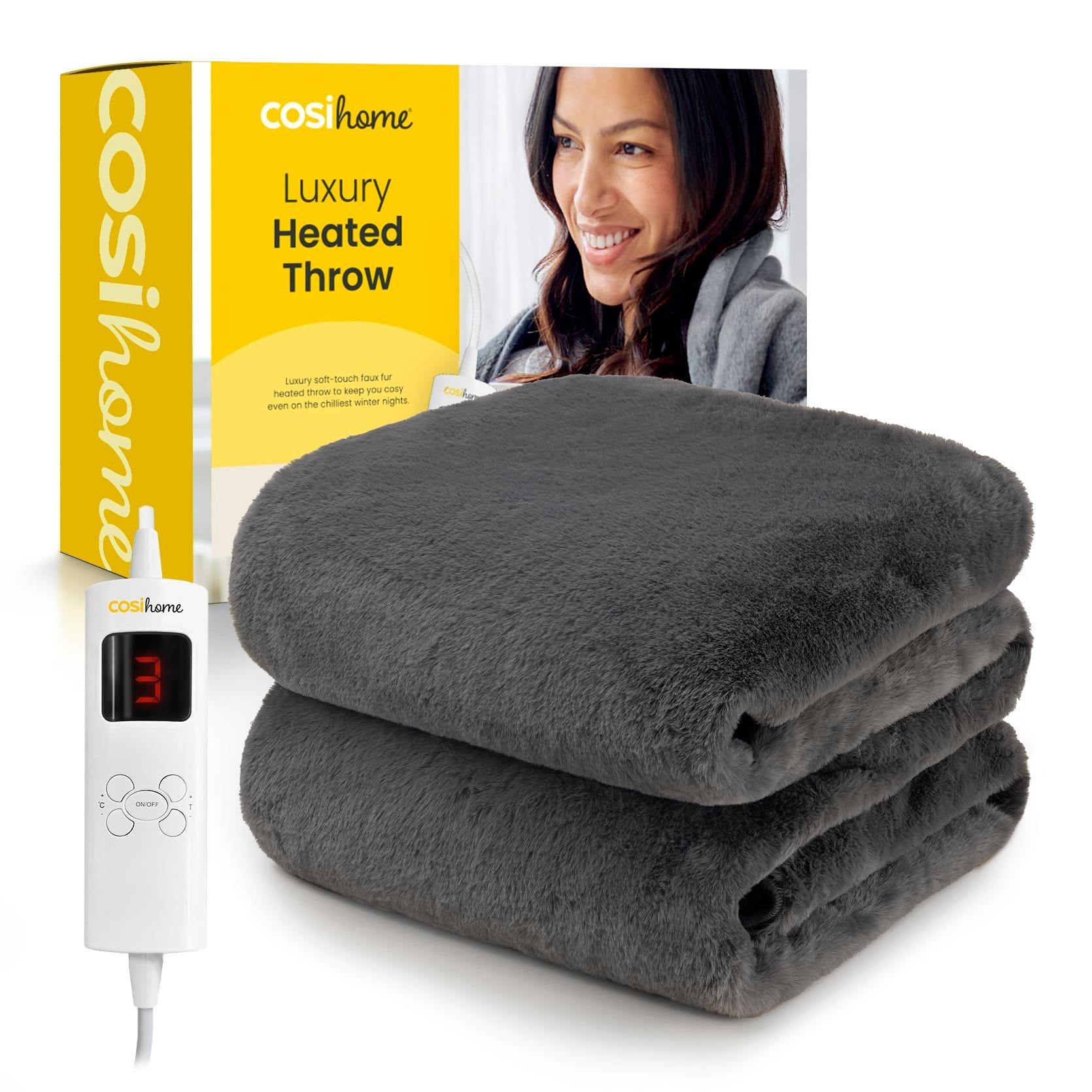Soft grey faux fur electric heated throw from Cosi Home, featuring a white control unit with a digital display for temperature settings, packaged in a bright yellow box.