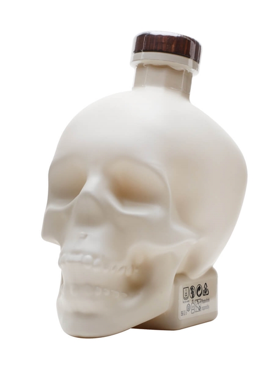 Limited edition Crystal Head Bone Vodka bottle shaped like a skull, featuring a matte white finish and a wooden stopper, with a capacity of 70 cl.