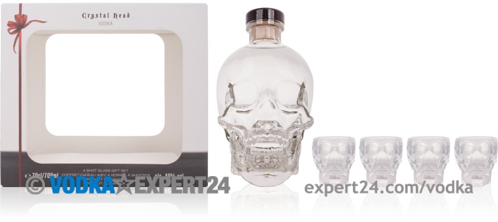 Clear glass skull-shaped vodka bottle with a sleek design, accompanied by four matching skull-shaped cocktail glasses, all presented in a decorative gift box.