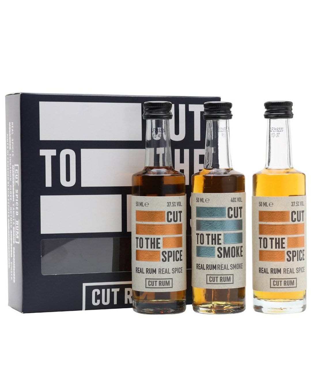 Three 5 cl bottles of Cut Rum in a black gift box, featuring labels in orange, brown, and cream, labeled "TO THE SPICE" and "TO THE SMOKE," showcasing different rum varieties.