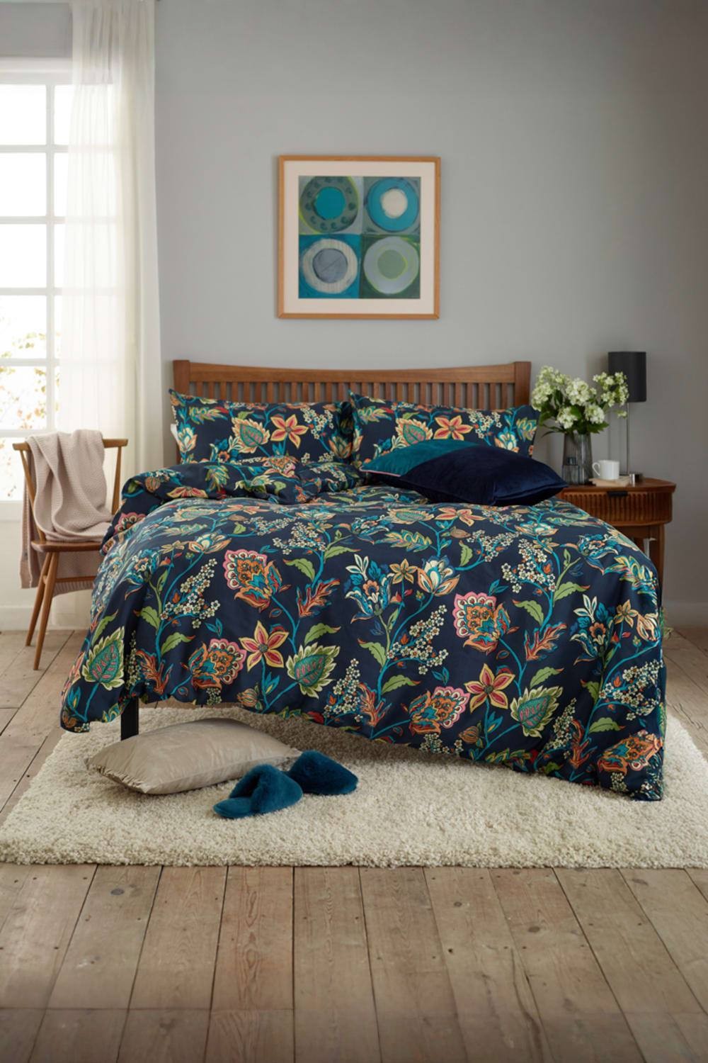 Dark navy duvet cover set featuring a floral print, made from 200 thread count cotton-rich material, styled with coordinating pillows and a cozy bedroom setting.