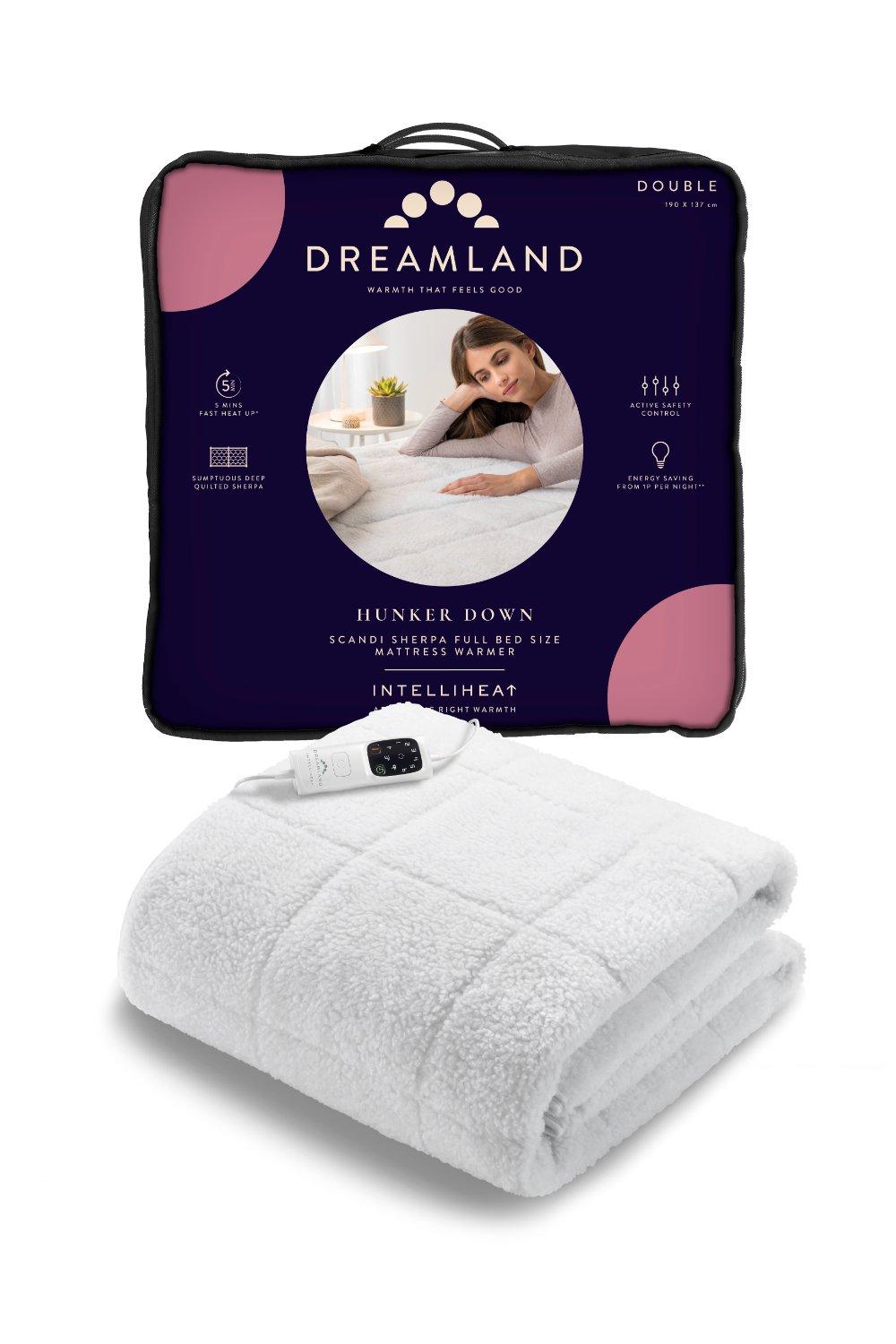White Sherpa underblanket with a quilted design, packaged in a purple and black carry bag, featuring a control unit for adjustable heat settings, labeled "Dreamland Hunker Down."