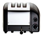 Black Dualit 2 + 1 Combi Vario 3 Slice Toaster with a stainless steel front, three slots, and adjustable browning control knobs on the side.