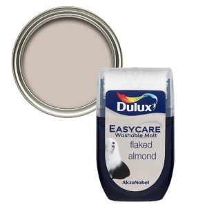 Dulux Easycare Flaked Almond Flat Matt Emulsion Paint in a 30ml tester pot, featuring a soft beige color with a smooth finish, displayed alongside a round metal lid.