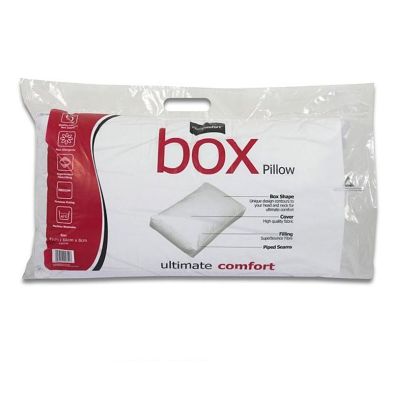 White box-shaped pillow packaged in a clear plastic bag with a red and white label, highlighting "ultimate comfort" and key features.
