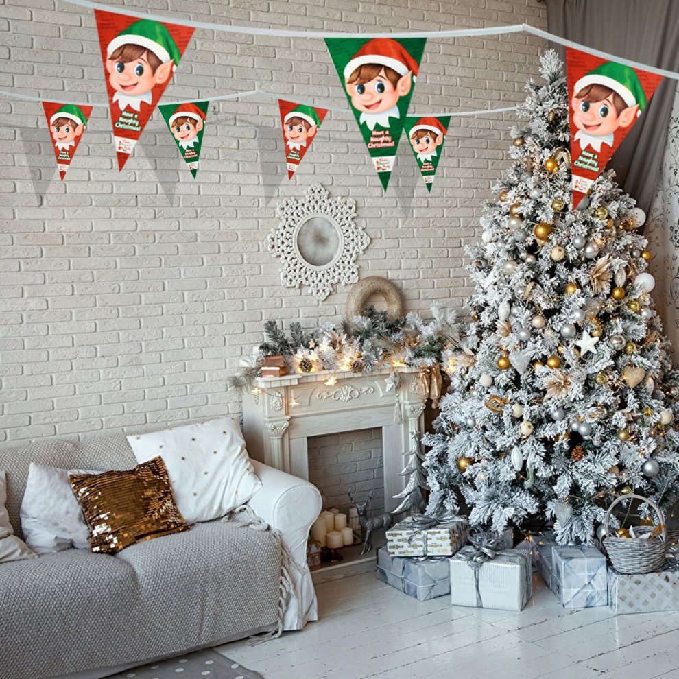 20ft triangular bunting flags featuring a naughty elf design in green and red, made of durable material, hanging above a decorated Christmas tree and cozy living room setting.