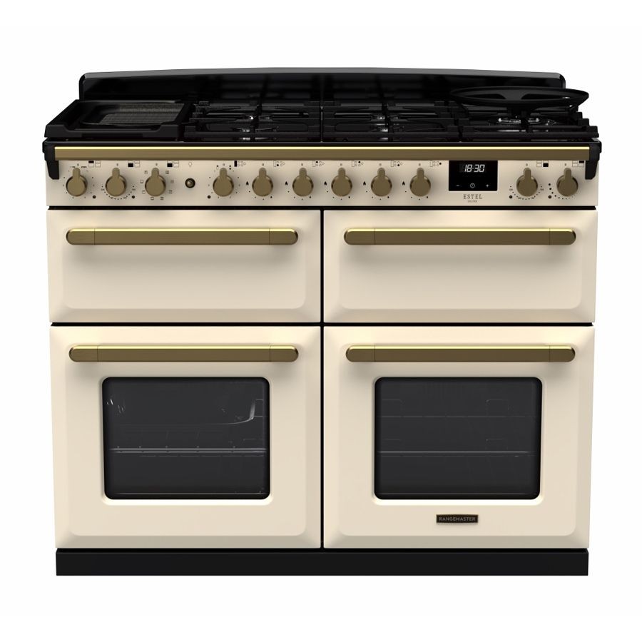 Pale cream dual fuel range cooker with antique brass accents, featuring four gas burners, two ovens, and a digital display, all set on a sleek black top.
