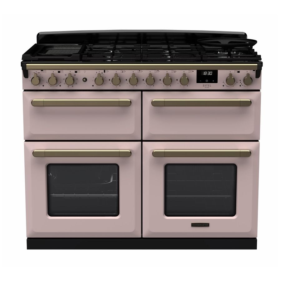 Dual fuel range cooker in pale pink with antique brass accents, featuring four gas burners, two ovens, and control knobs for precise temperature adjustments.