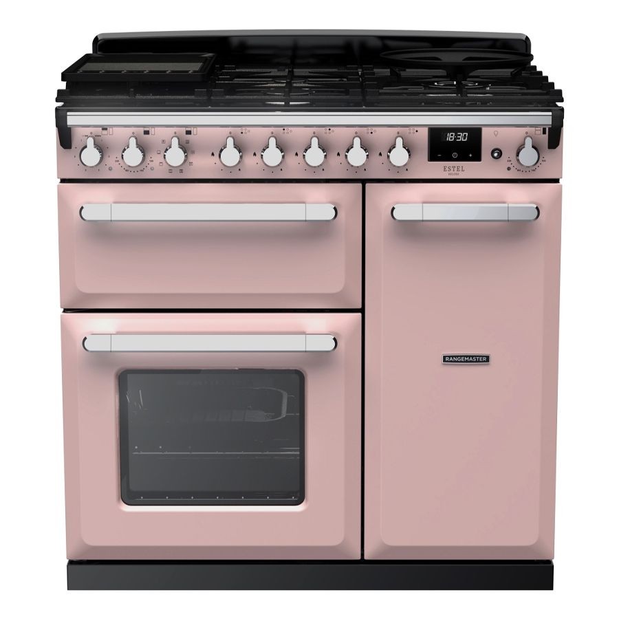 Pale pink dual fuel range cooker with chrome accents, featuring four gas burners, two ovens, and control knobs, showcasing a retro design by Rangemaster.