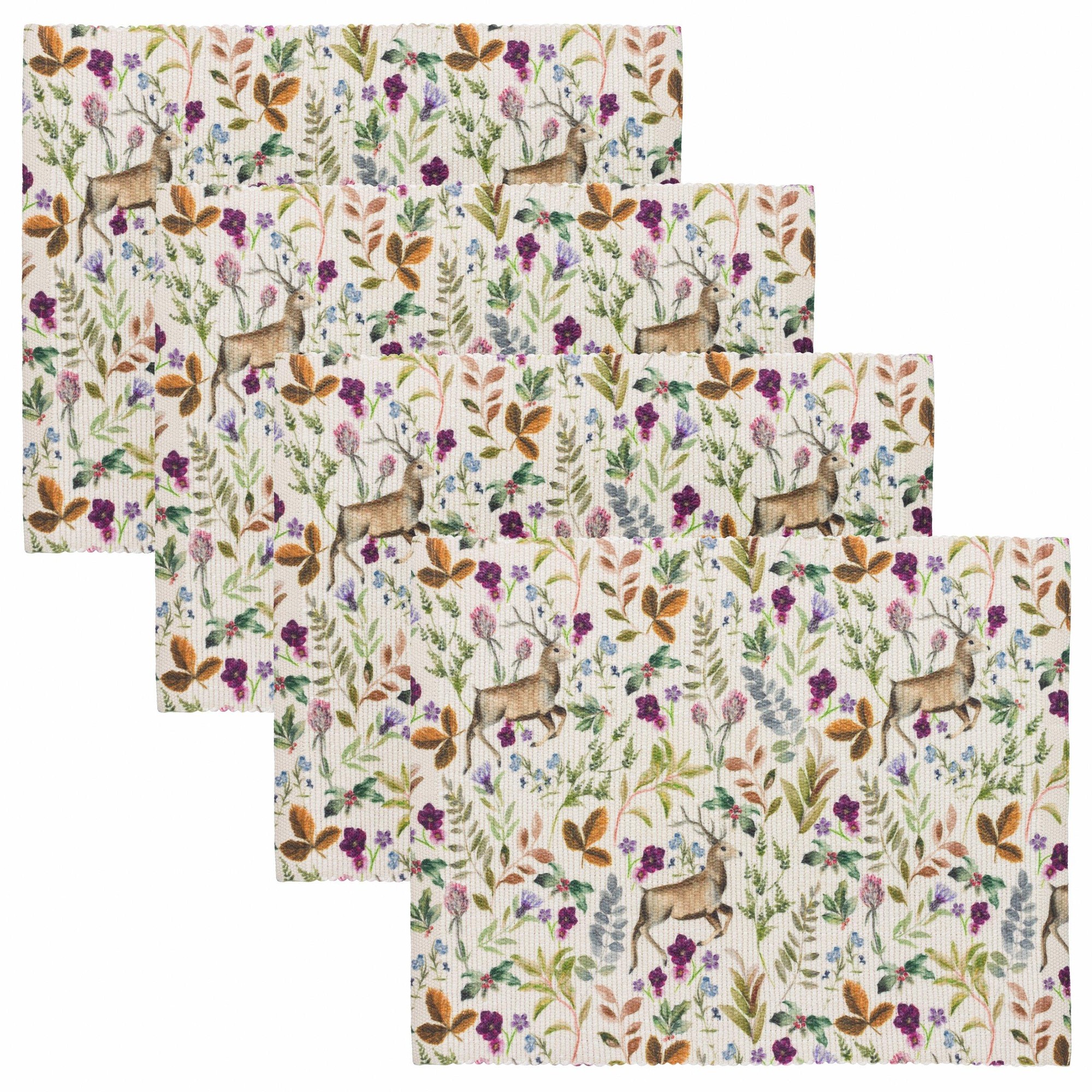 Set of four berry-colored placemats featuring a digitally printed design with reindeer, flowers, and foliage on a textured background.
