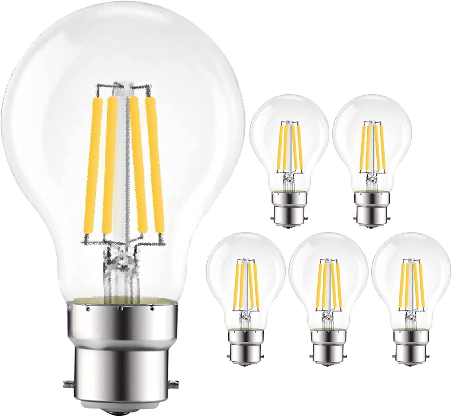 Clear glass LED filament light bulbs with a B22 base, featuring four vertical yellow filaments, packaged in a set of six, emitting a warm 2700K white light.