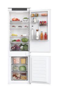Integrated white fridge freezer with a 70/30 split, featuring transparent shelves, drawers for fresh produce, and a variety of drinks and food items visible inside.