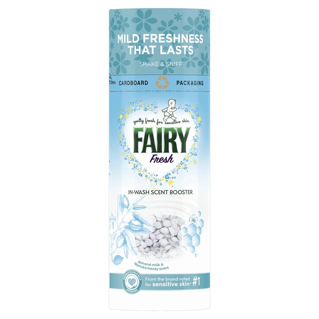 Tall cylindrical cardboard container with a light blue and white design, featuring the "Fairy Fresh" logo, and filled with small white scent booster beads.