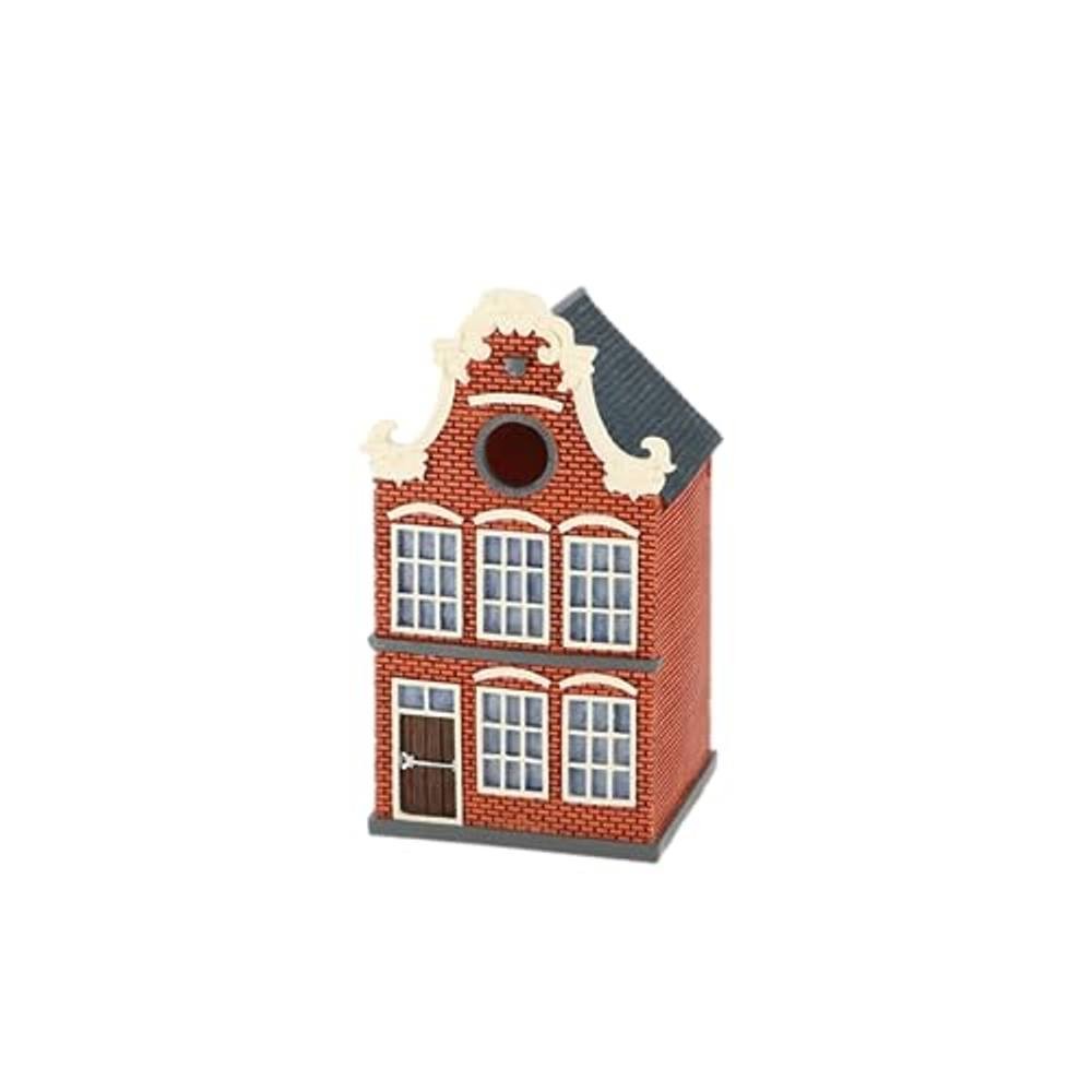 A charming birdhouse designed like a Dutch canal house, featuring red brick walls, white window frames, and a gray roof with decorative gables.