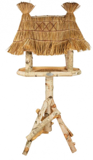 Wooden feeding table with a natural finish, featuring a thatched roof made of straw, supported by a sturdy, rustic log base, measuring 56 x 81 x 156 cm.