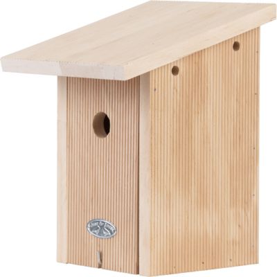 Wooden birdhouse with a slanted roof, featuring vertical grooves, a circular entrance hole, and a metal logo plate, presented in a gift box.