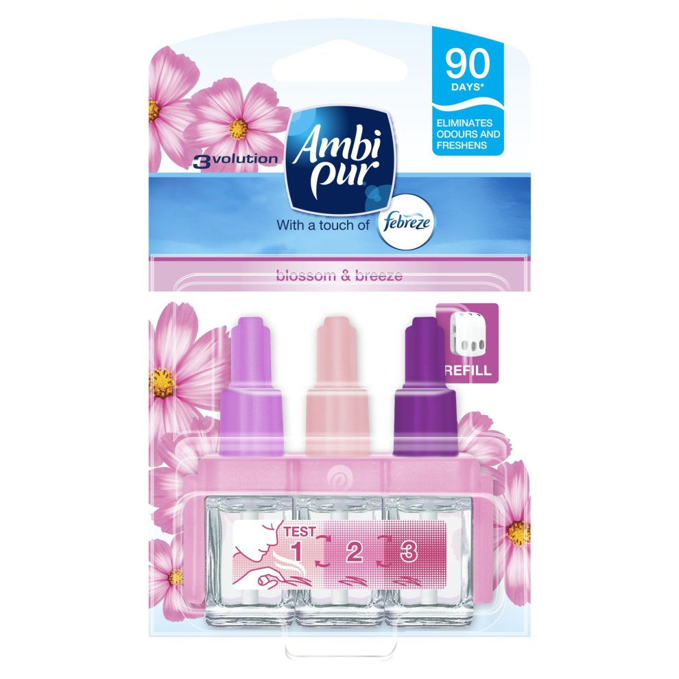 Febreze 3Volution air freshener refill in Blossom & Breeze scent, featuring three colorful bottles (pink, purple, and clear) in a floral-themed packaging, designed for plug-in use.