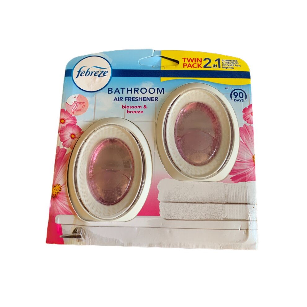 Twin pack of Febreze Bathroom Air Freshener in Blossom & Breeze scent, featuring two oval-shaped dispensers with pink and white designs, providing freshness for up to 90 days.