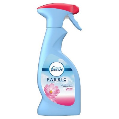Light blue spray bottle with a red trigger cap, labeled "Febreze Fabric" in white and blue text, featuring a floral design and the scent name "Blossom & Breeze."