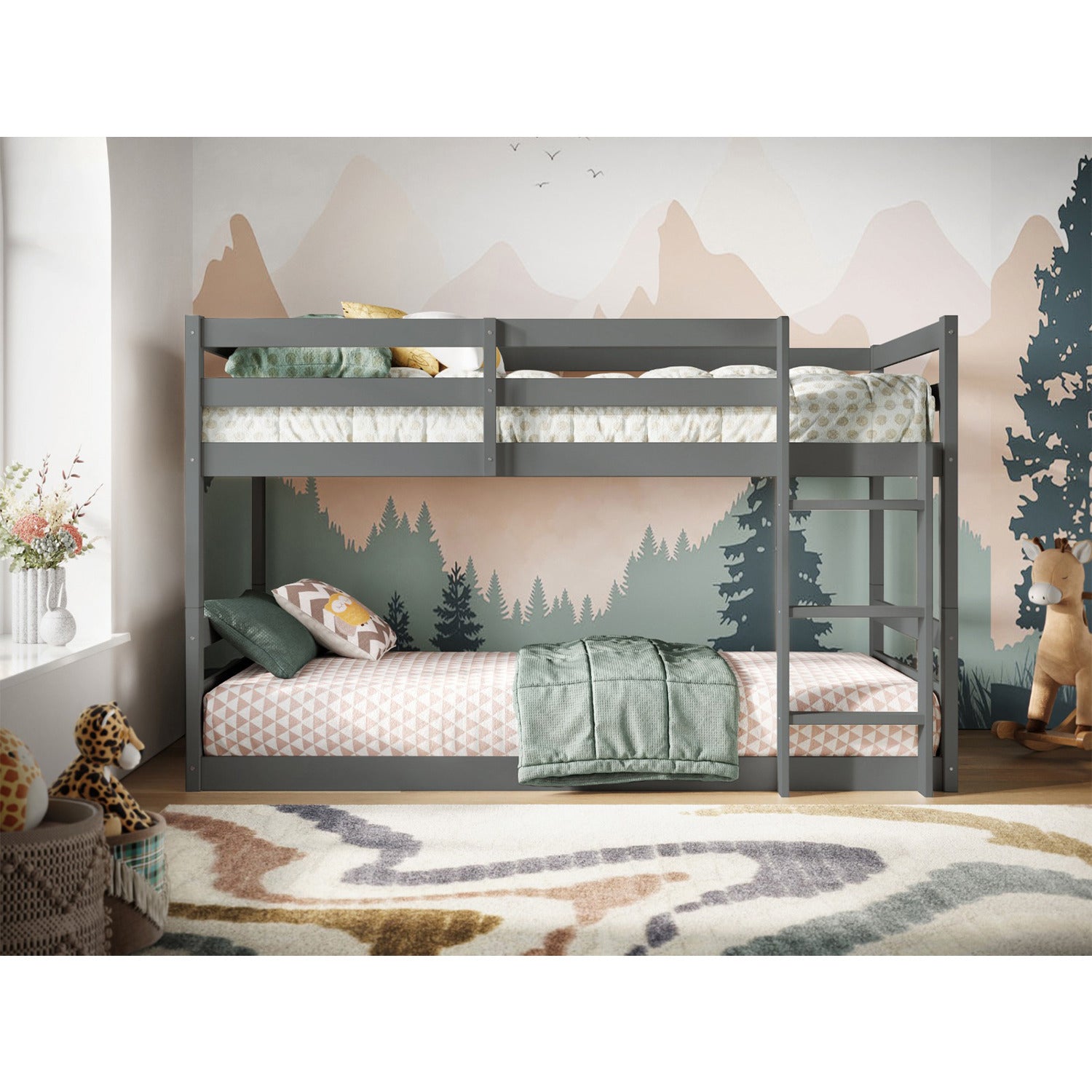 Flair Furniture Flair Shasha Low Shorty Bunk Bed in grey, featuring a sturdy metal frame, two sleeping areas with mattresses, and a modern design against a nature-themed backdrop.