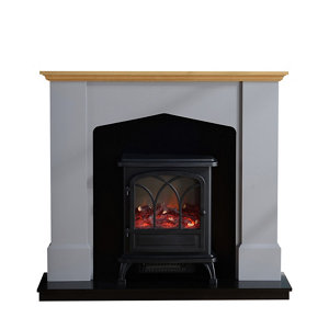 Grey electric stove suite featuring a traditional design with a black stove, arched glass door, and a wooden mantelpiece, set against a sleek black base.
