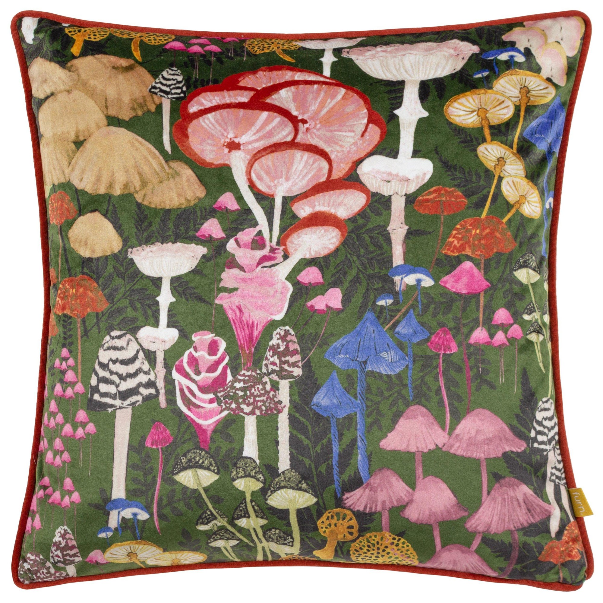 Colorful velvet cushion featuring an abstract mushroom design with various mushroom shapes in pink, red, and yellow against a green background, bordered with a red piped edge.