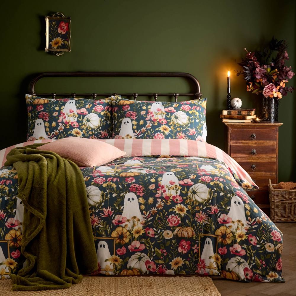 Reversible double duvet cover set featuring a botanical print with whimsical ghosts, vibrant floral patterns, and a striped design, complemented by a green throw and decorative pillows.