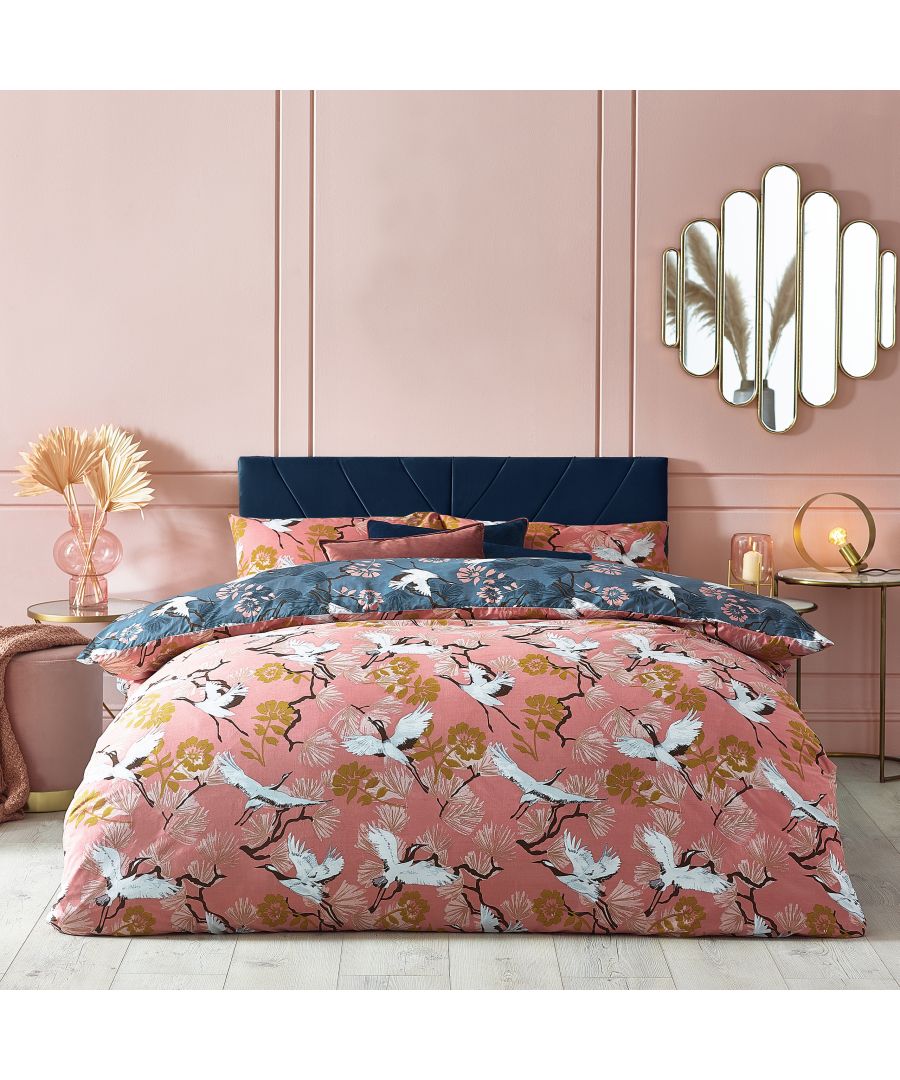 Reversible duvet cover set featuring a blush cotton side with floral and crane patterns, and a navy side with contrasting designs, suitable for a double bed.