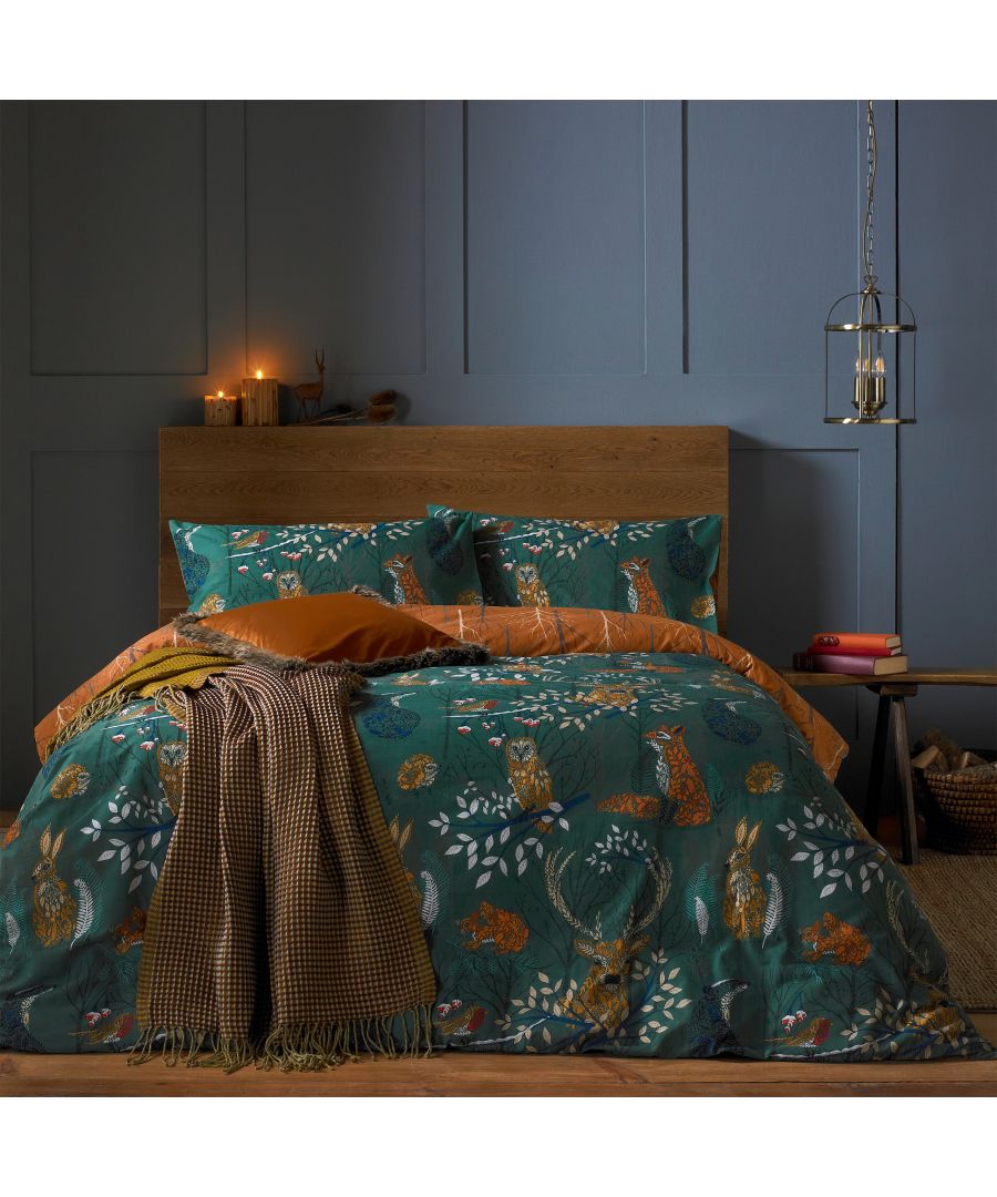 Emerald reversible duvet cover set featuring woodland fauna, with intricate animal and foliage patterns, paired with coordinating pillowcases and a textured throw blanket.