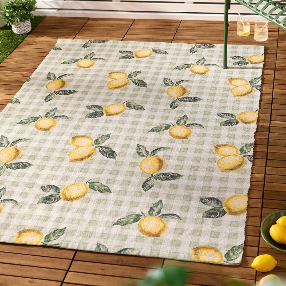 Striped indoor/outdoor rug featuring a green checkered pattern with vibrant yellow lemons and green leaves, made from durable material suitable for various settings.