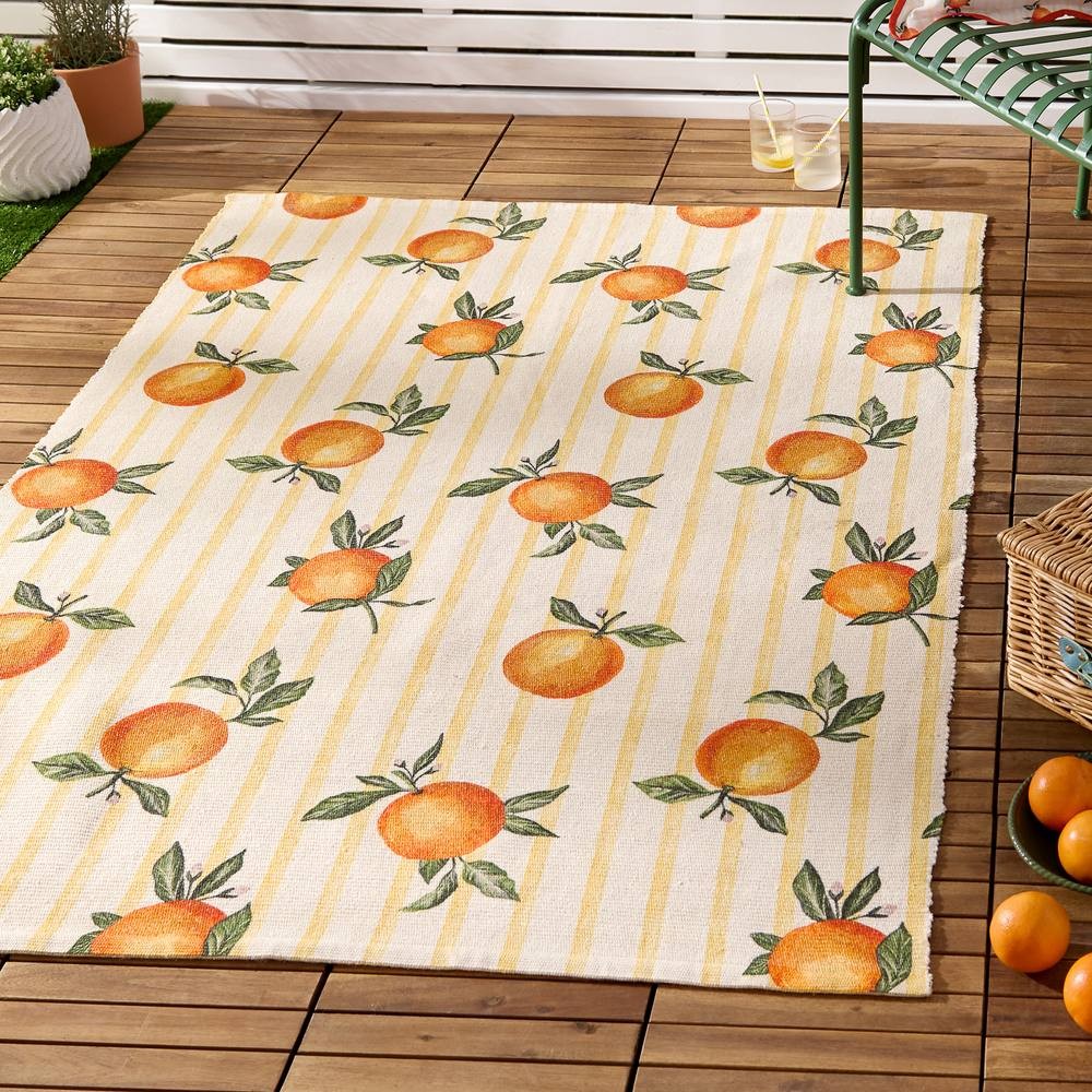 Yellow indoor/outdoor rug featuring a gingham pattern with vibrant orange fruits and green leaves, made of durable material suitable for various settings.