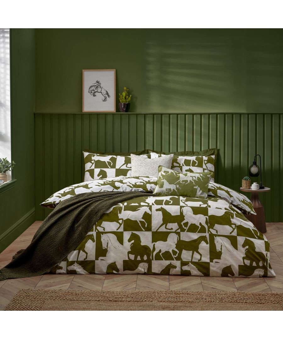 Reversible duvet set in olive green featuring a horse print, complemented by matching pillowcases and a decorative cushion, styled in a cozy bedroom setting.