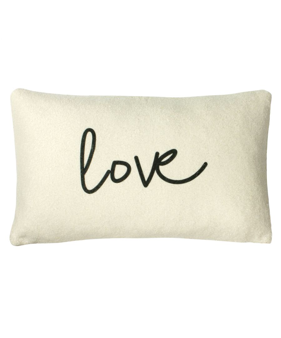 Cream shearling cushion measuring 30 cm x 50 cm, featuring a black cursive "love" text design on the front.