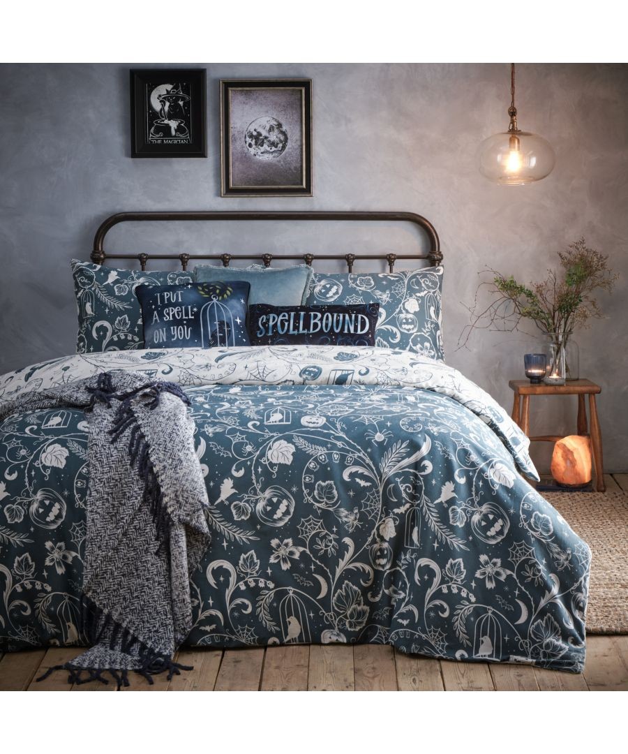 Spellbound brushed cotton duvet cover set in blue, featuring whimsical white floral and ghost patterns, complemented by matching pillowcases and a cozy textured throw.