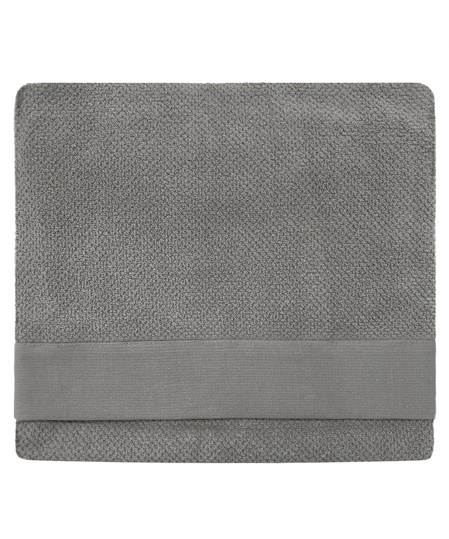 Textured grey towel featuring a woven design, with a smooth band along one edge, showcasing a soft, absorbent material ideal for bath use.