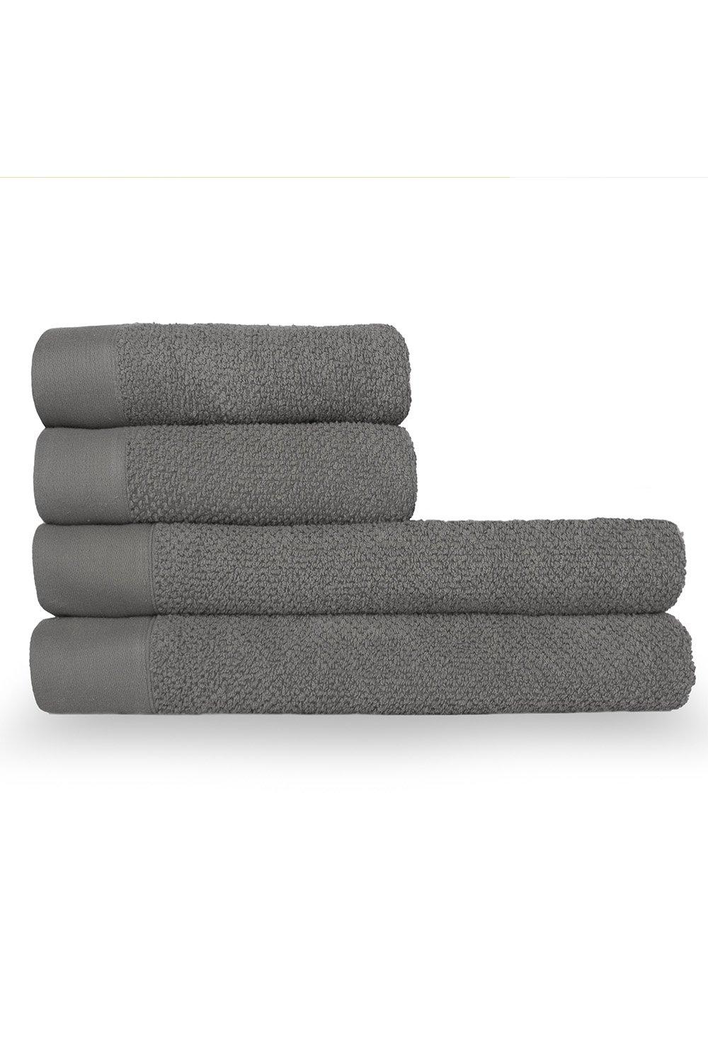 Textured weave cotton towel bale in a soft gray color, featuring four neatly stacked hand and bath towels with contrasting smooth edges.