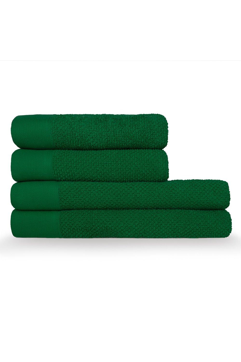 Four green cotton towels stacked neatly, featuring a textured weave design with smooth and plush sections, ideal for hand and bath use.