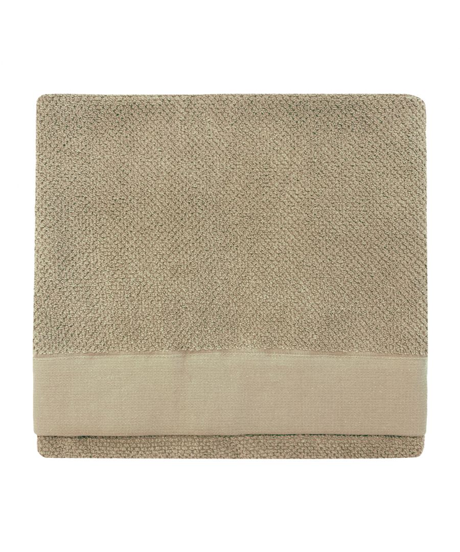 Textured weave bath towel in a natural cotton fabric, featuring a soft beige color with a smooth border, folded neatly for display.