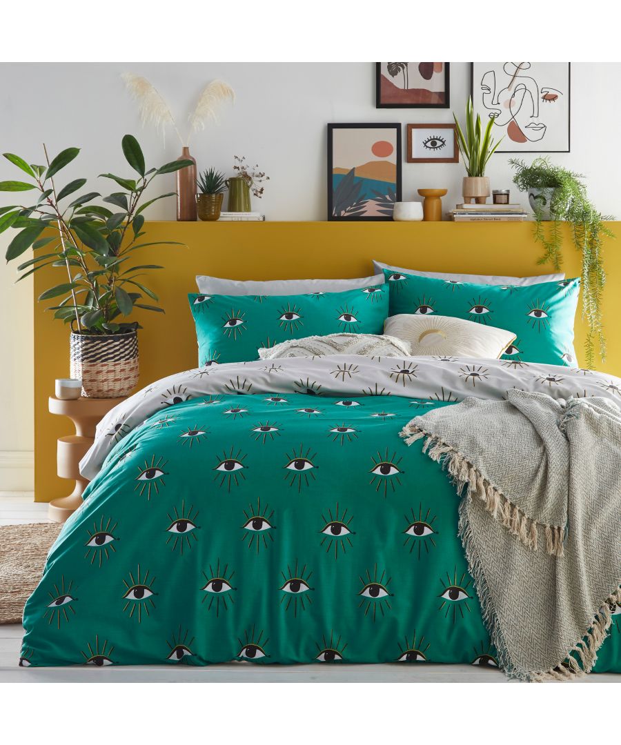 Green cotton duvet cover set featuring an abstract eye pattern, complemented by matching pillowcases and a textured throw, set against a vibrant yellow wall and decorative plants.