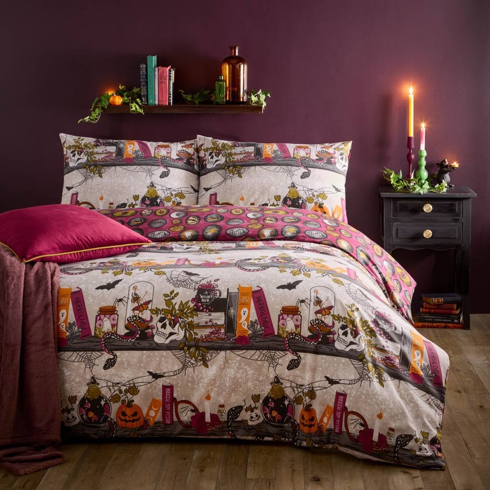Multi-colored reversible duvet set featuring whimsical witch-themed prints, including books, candles, and bats, with coordinating pillowcases and a rich purple backdrop.