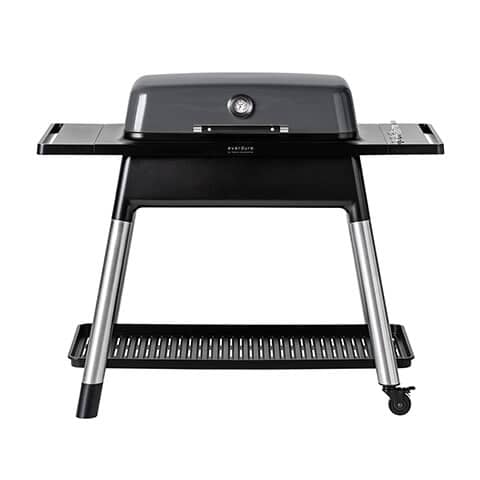 Graphite-colored 3-burner gas BBQ with a sleek design, stainless steel legs, built-in thermometer, and side shelves for preparation and storage.