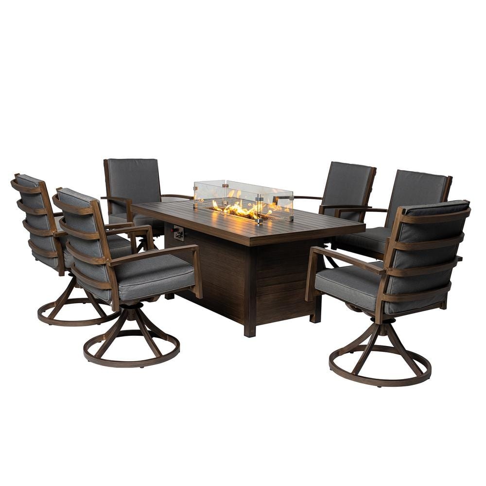 7-piece aluminum patio dining set featuring a rectangular fire pit table with a glass wind guard, surrounded by 6 gray-cushioned swivel chairs with wooden frames.