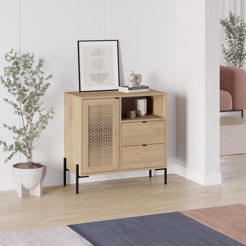 Sapphire oak effect sideboard cabinet in brown with one door, two drawers, and a decorative cane panel, set against a light room with a plant and artwork.